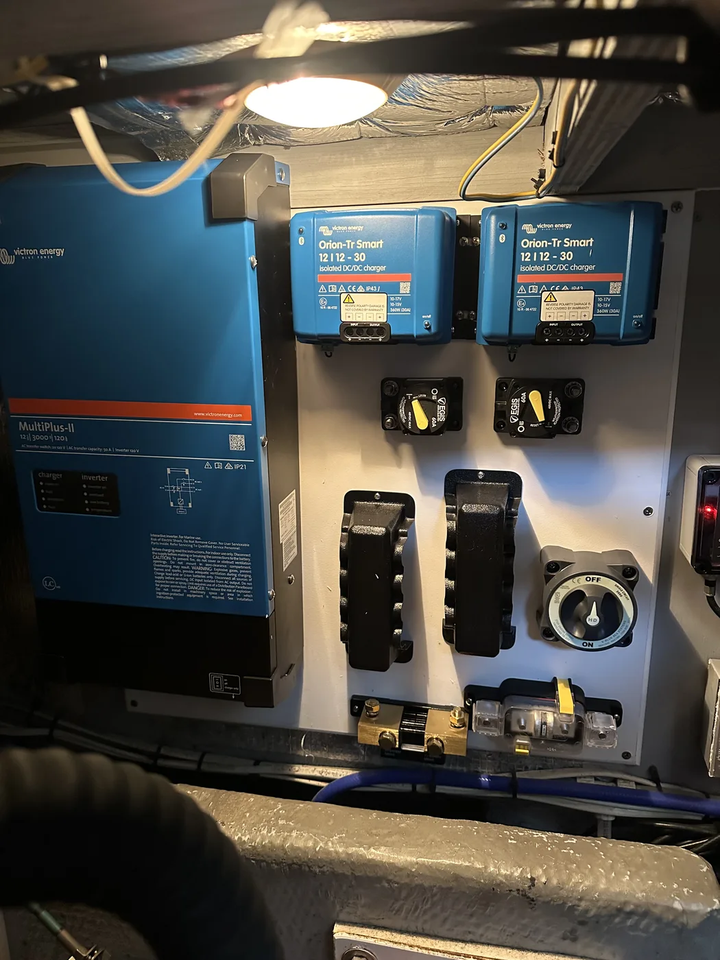 Dual Orion-Tr Smart chargers, Egis breakers, and a battery disconnect switch wired into a power distribution panel