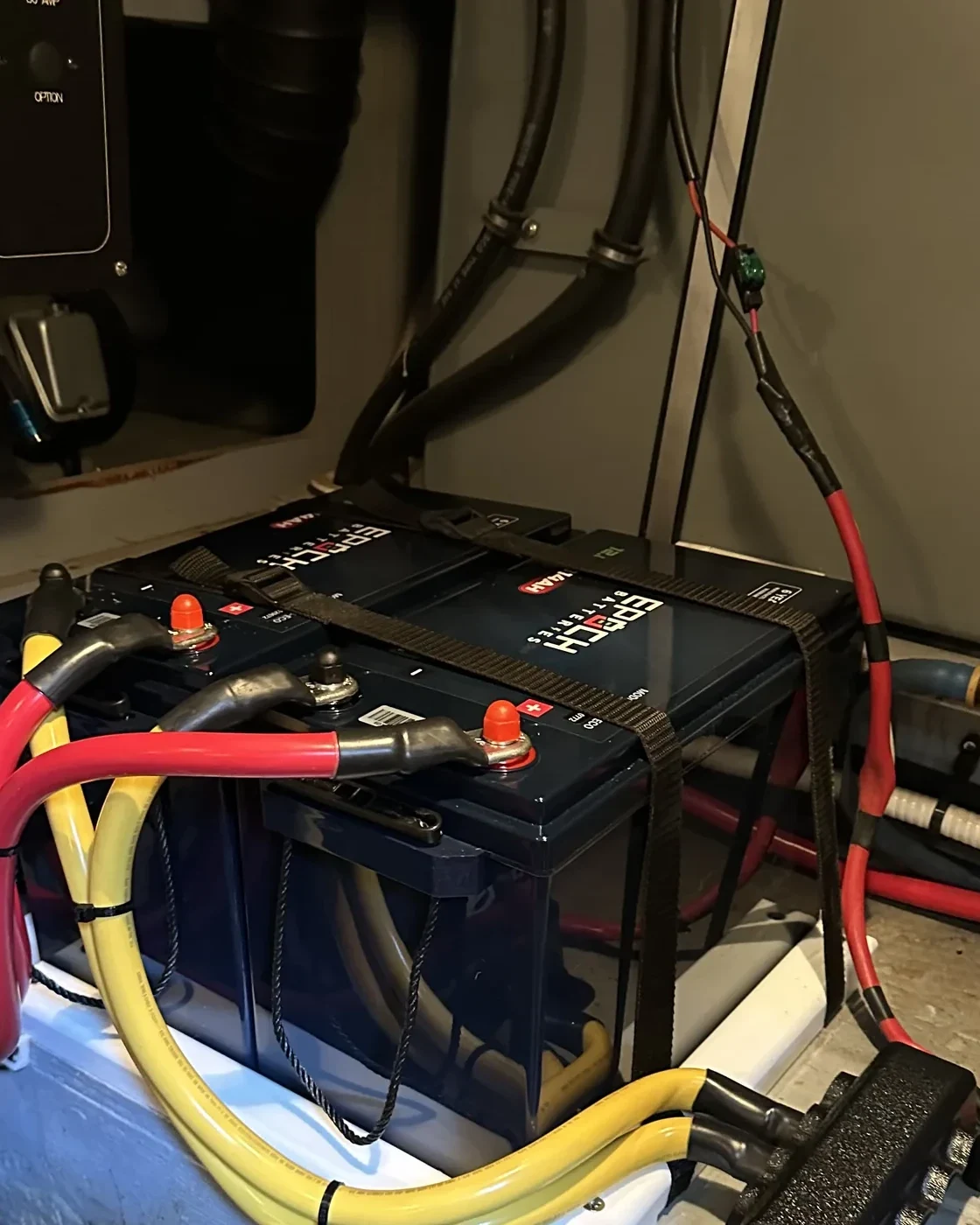 A stacked lithium battery bank wired with heavy-gauge cabling and properly sized disconnects