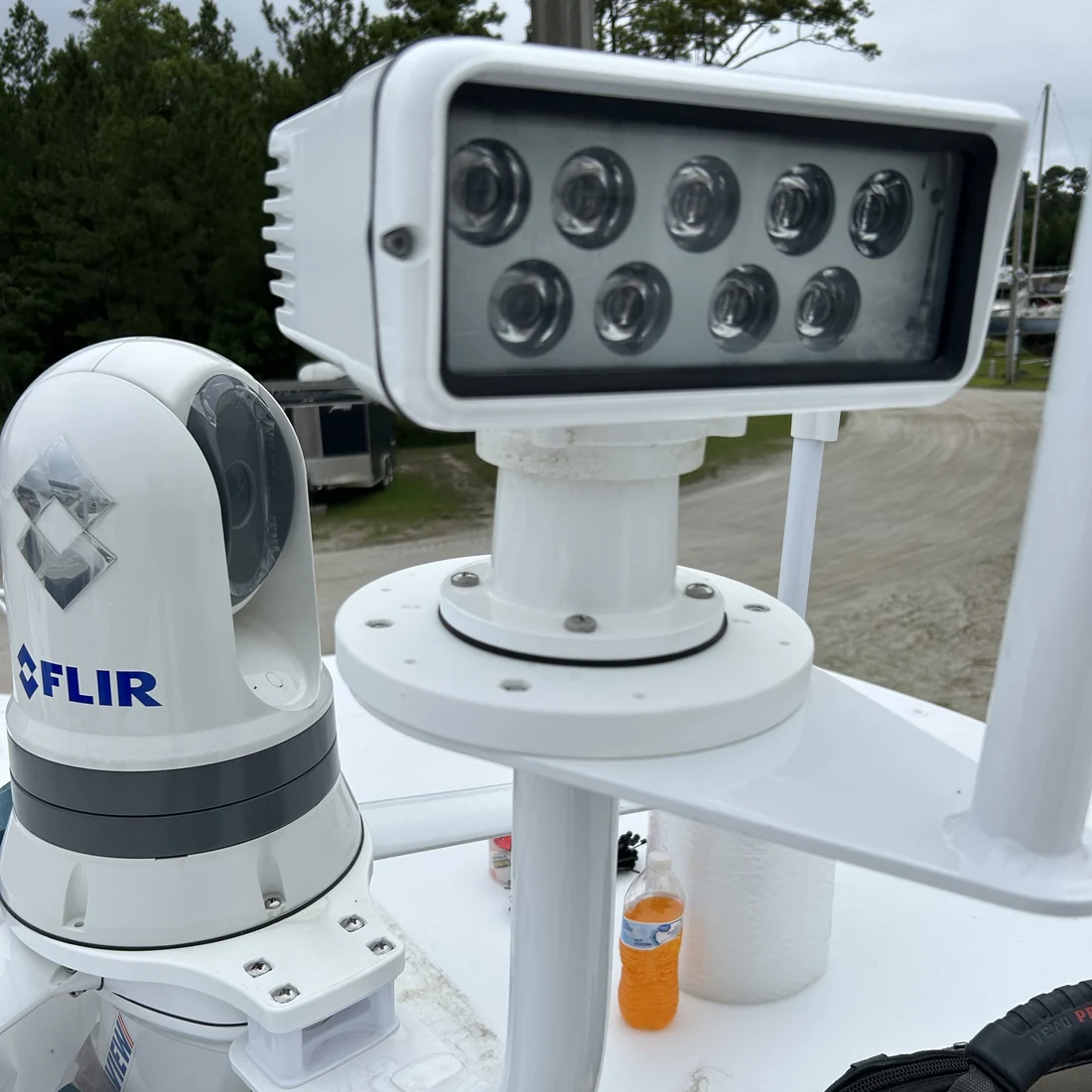 A FLIR thermal camera and floodlight mounted and wired on a boat's radar arch