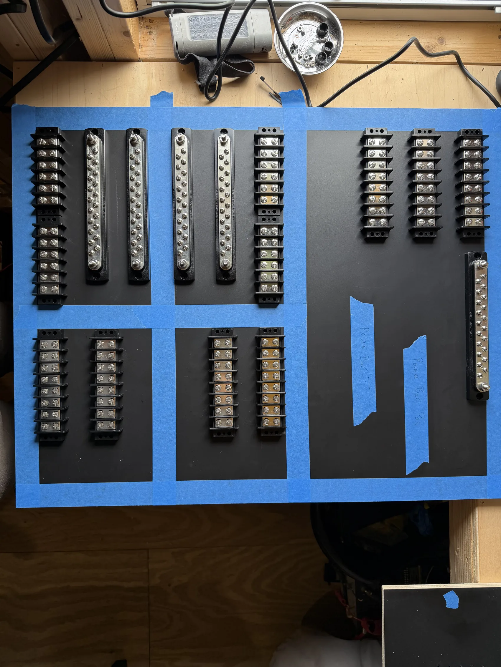 Bus bars and terminals laid out on a custom panel before final assembly