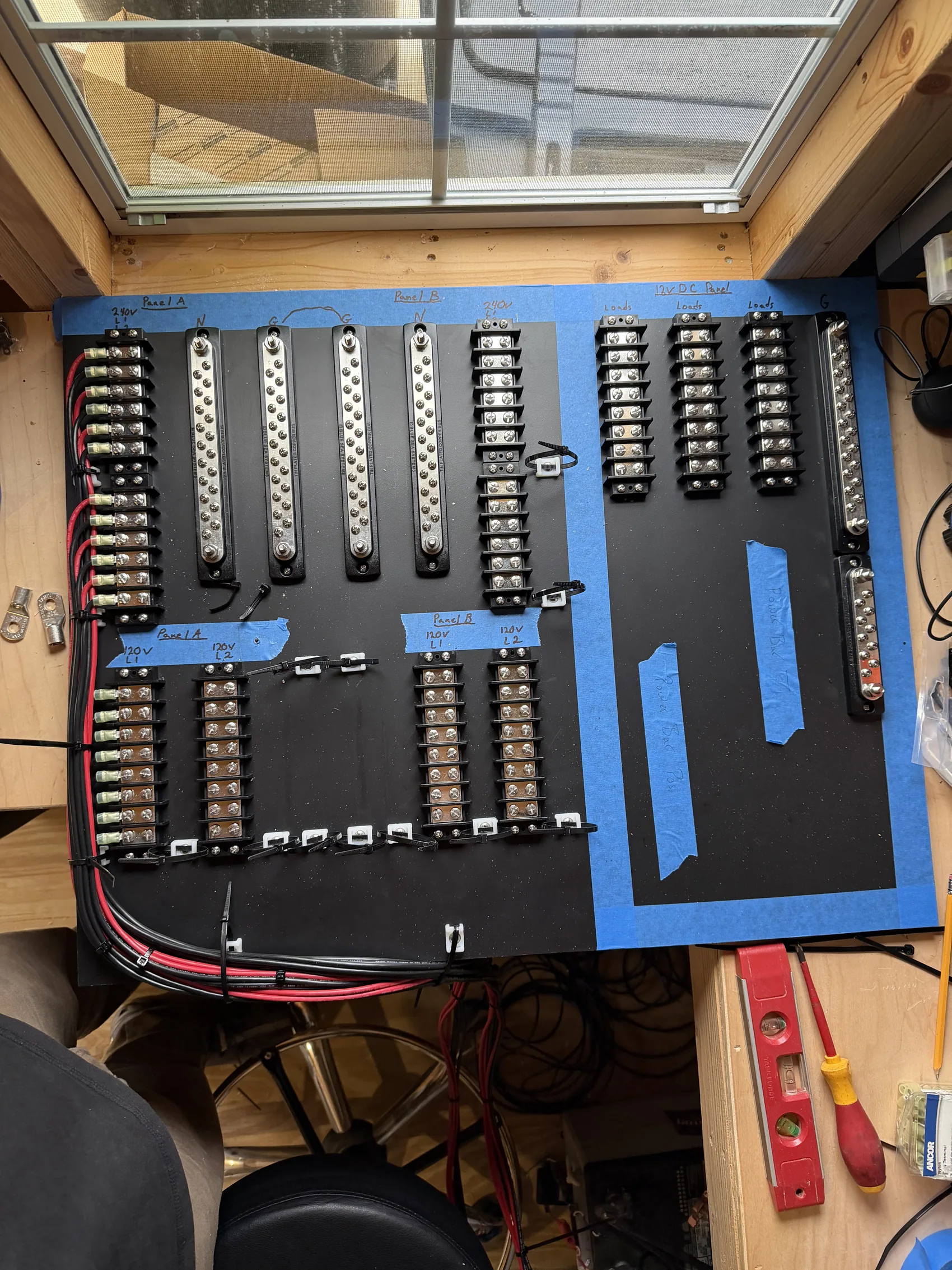 A custom distribution panel dry-fit and laid out on the bench before a single wire is run