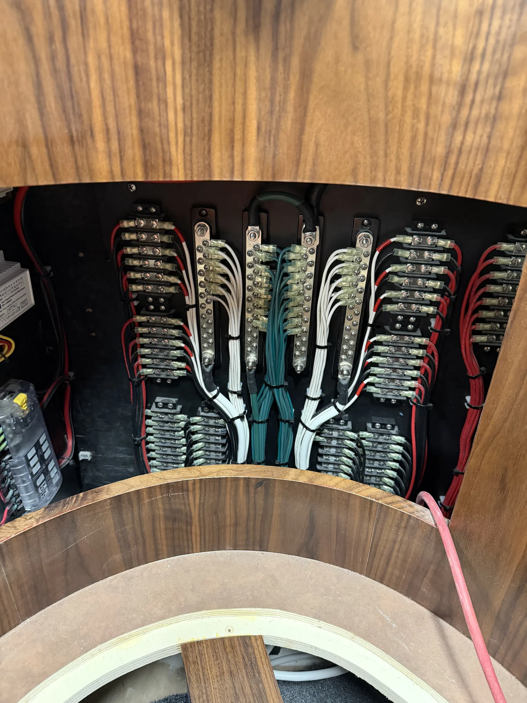 Rows of labeled ring terminals landed on tinned bus bars inside a custom-built panel