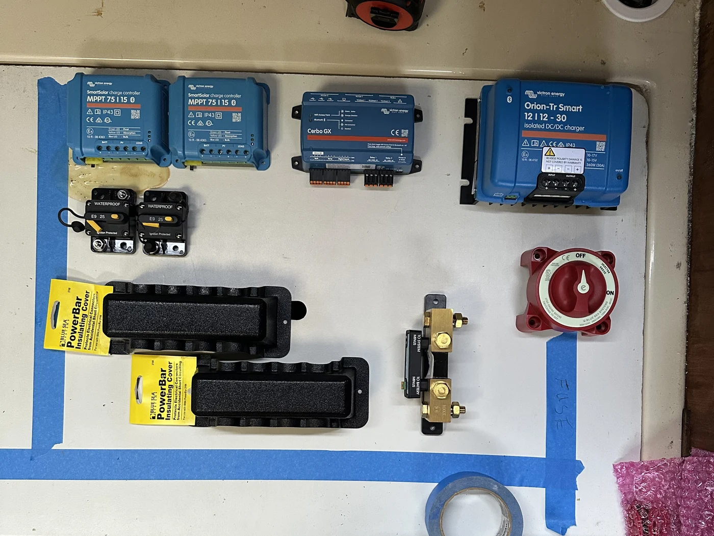 Victron power system components laid out and planned on the bench before a single wire is run
