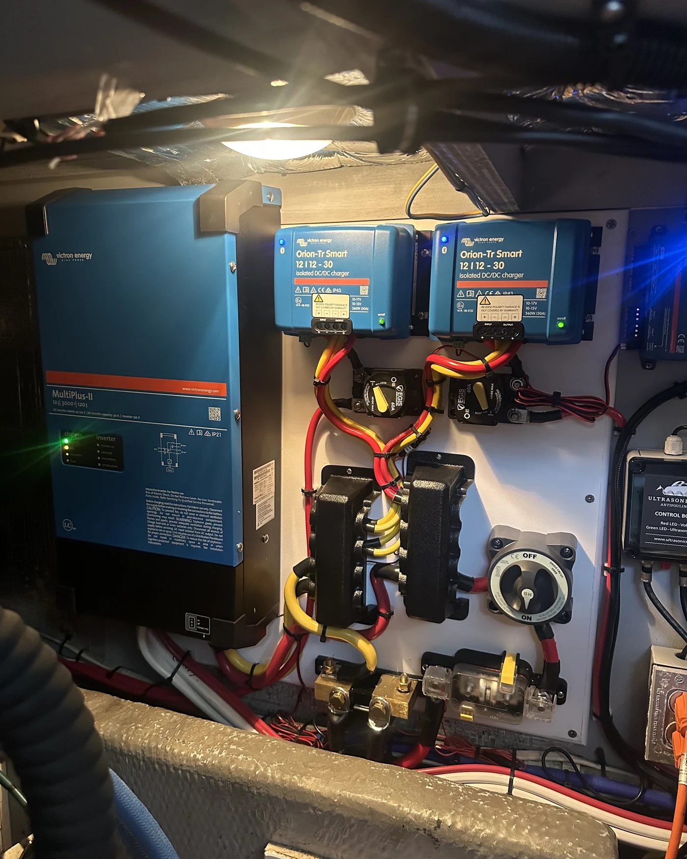 A Victron power stack installed aboard a customer's boat: dual Orion-Tr Smart DC-DC chargers, EGIS breakers, and a MultiPlus-II inverter/charger wired together as one system