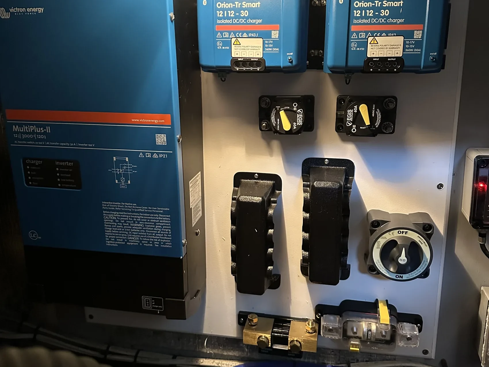 A Victron MultiPlus-II inverter/charger, dual Orion-Tr Smart DC-DC chargers, EGIS breakers, a battery disconnect switch, and a battery monitor shunt, wired together from a recent Coastal Current installation